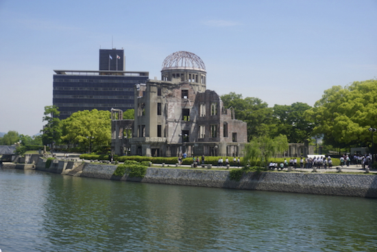 The atomic bomb dome left standing on the peaceful river bank.