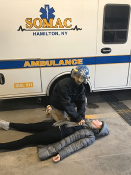 SOMAC Ambulance Corps volunteer demonstrating intervention on a fellow student.