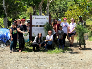 COVE students in Puerto Rico in front of a sign