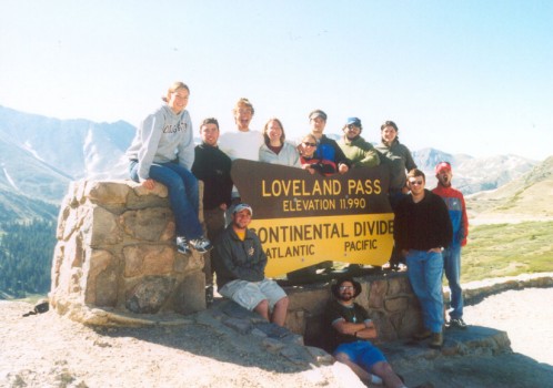 Students pose for a picture around the Loveland Pass sign