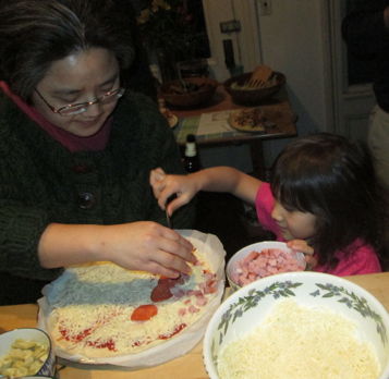 Myongsun & Julia Peck work on a Magma Chamber Pizza. (Maybe that should have been a 'deep crust' pizza??)