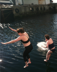 Sara Reese '16 (left), Claire Freehafer '15 (right), and Hailey Elder (in water) jump into the northern Atlantic Ocean.