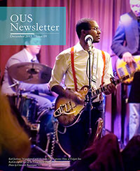 Cover of the December newsletter with a student playing guitar
