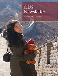 Female student with a Colgate teddy bear walks along the Great Wall of China