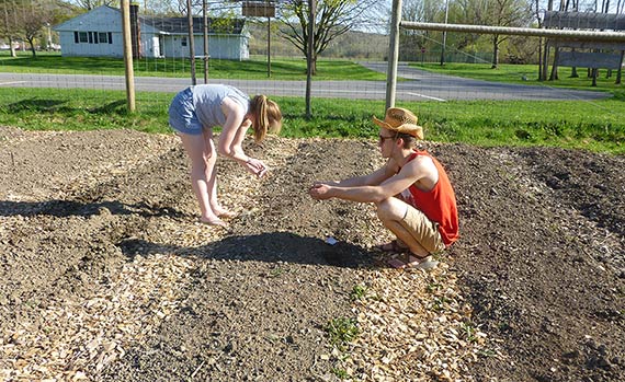 Two students working to plant the Community Garden at Colgate.