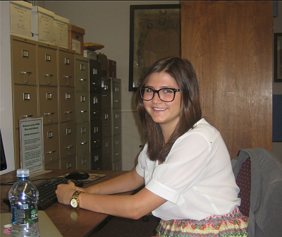 Kennedy Pope '15 is working with documents related to the history of business in Utica with the Oneida County Historical Society