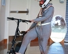 Actress Dani Solomon '13 in a jumpsuit prepares to mount a bicycle on set